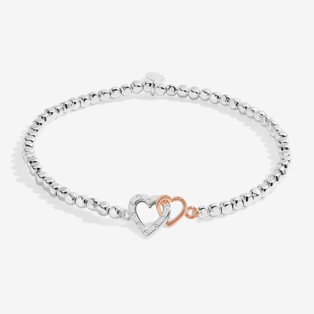 Silver beaded bracelet with interlinked silver and rose gold heart charms