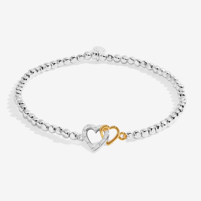 Silver beaded bracelet with interlinked silver and gold heart charms