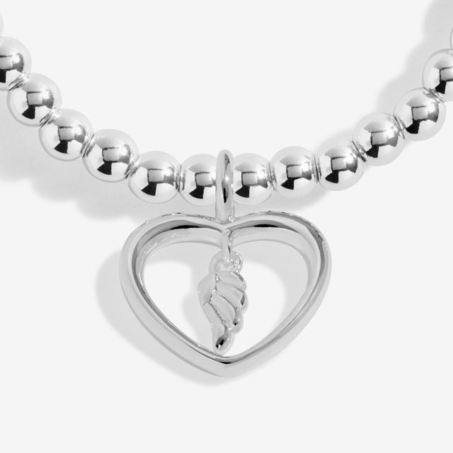Close up of interlinked heart charm on silver mum bracelet