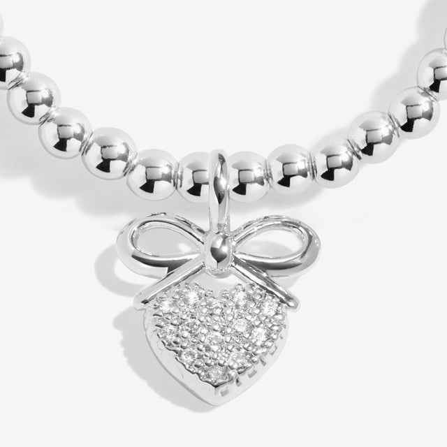 Close-up of pavé heart and bow charm on Joma Prom bracelet