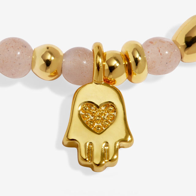 Joma Jewellery Protection bracelet charm close up gold plated detail