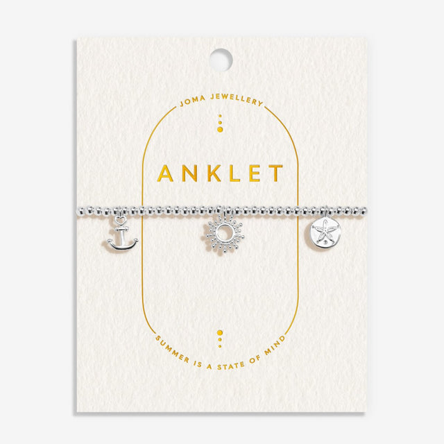 Joma Jewellery silver charm anklet on gold-foiled textured buttercream card