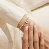 Silver and gold heart charm bracelet for daughter worn on wrist