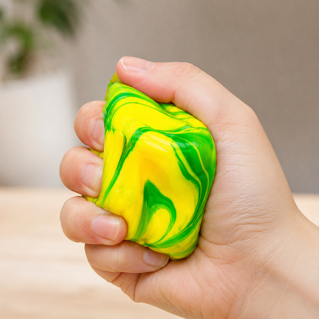Marble Cube sensory fidget toy being squeezed in hand for stress relief, anxiety reduction and improved focus