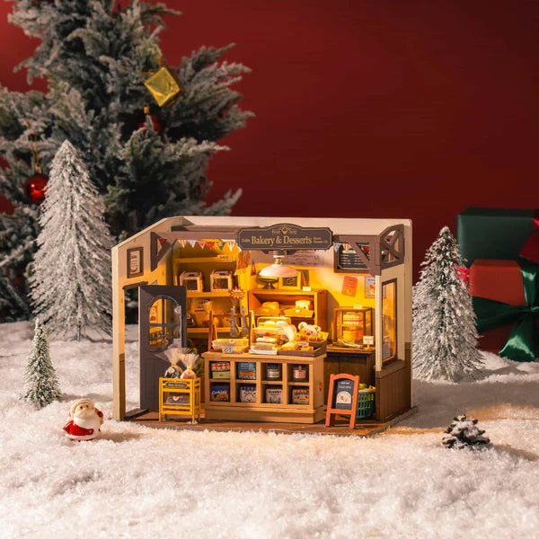 Robotime Rolife kits Becka’s Baking House full miniature view with counter, signage and detailed décor in Christmas scene