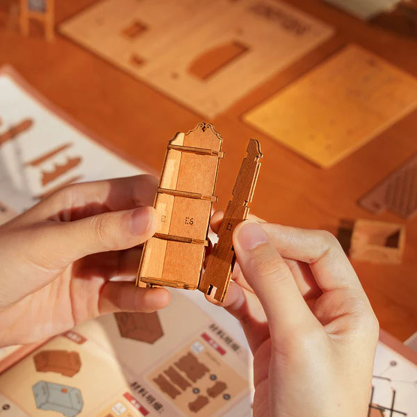 Robotime Rolife kits Corner Bookstore DIY miniature house being assembled with wooden pieces