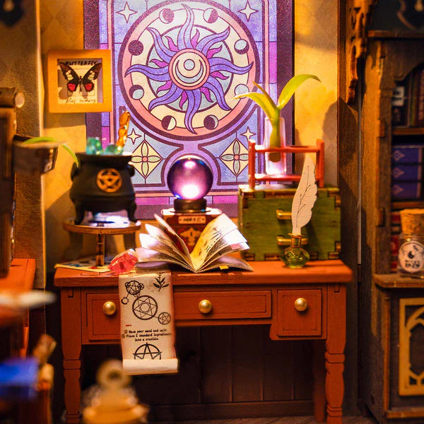 Rolife Magic Study miniature close-up showing crystal ball, books and potion bottles on desk