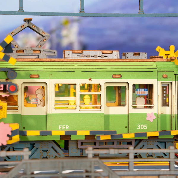 Close-up of Rolife Sakura Journey wooden pieces highlighting tram details and sakura design