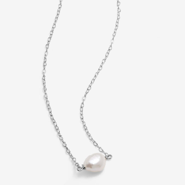 Close up of silver pearl necklace chain and pearl centre