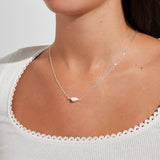 Woman wearing delicate silver pearl necklace
