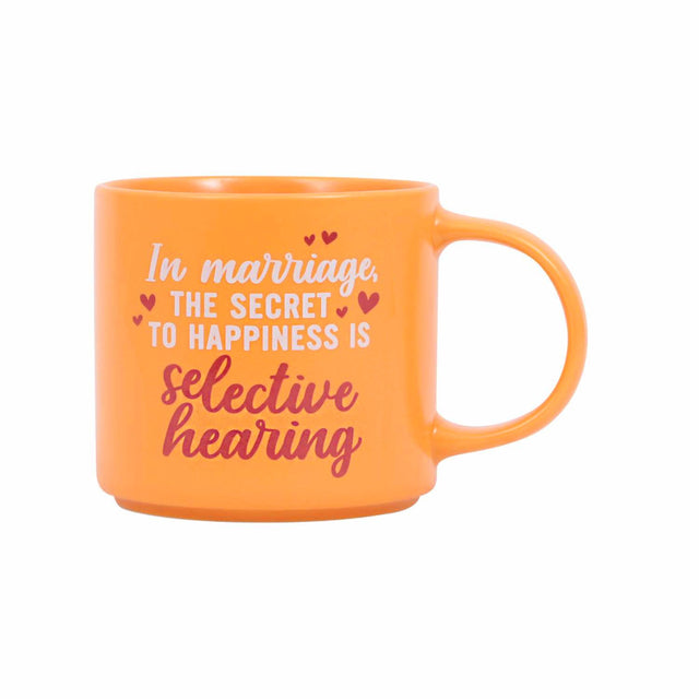 Splosh Cheeky Mug Marriage – orange ceramic mug with pink and white text reading “In marriage, the secret to happiness is selective hearing.” Funny witty mug for couples.