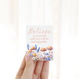 Splosh Cottage Grove Believe decorative ceramic fridge magnets displayed with other ceramic magnets in the collection.