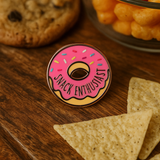 Close-up of Splosh Snack Lover enamel pin shaped like a pink donut