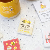 Bee-themed ceramic love magnet displayed on a surface