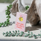 Bee-themed ceramic love magnet displayed on a surface