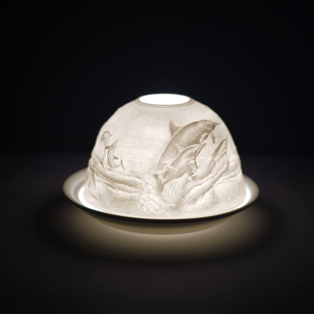 Cello porcelain tealight holder dome, in our dolphin design. This design displays dolphins leaping out of the ocean together. We offer a wide range of porcelain tealight holders to let you choose your show stopping piece and show it off with pride when guests and family are over.