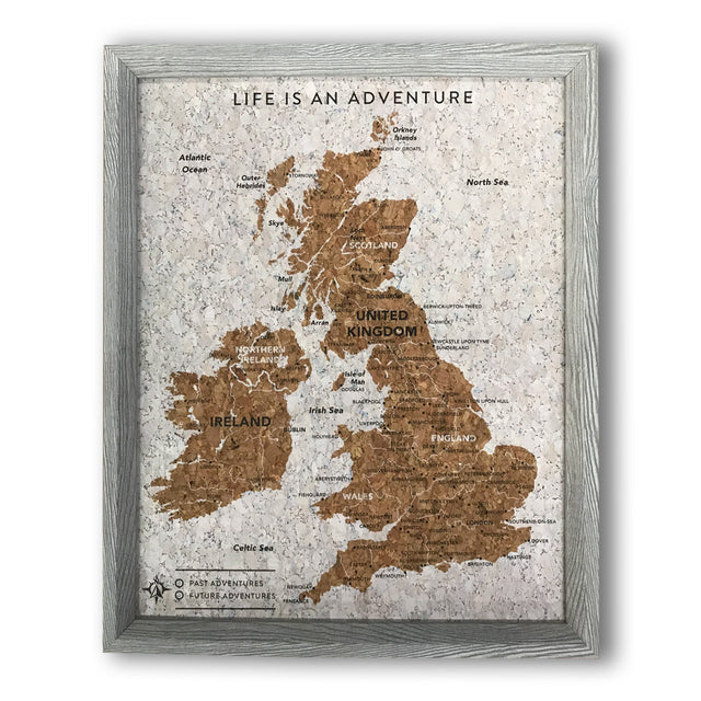 Splosh Travel Map â€“ Small UK Map with Grey Frame, Gold Land Detail, and Cork Board Backing. Features personalised labels for your pins, tracking past and future travels across the UK. Includes 'Life is an Adventure' text and hooks for easy wall mounting, perfect for home dÃ©cor or as a thoughtful gift.